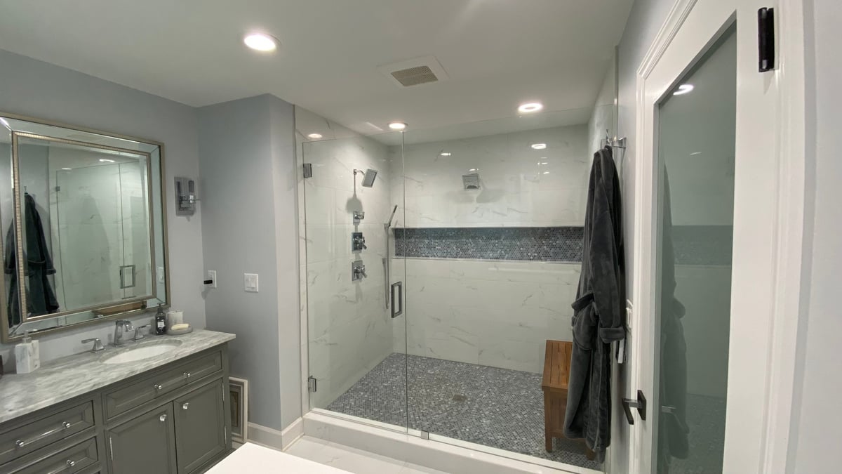 Walk-in shower with full wall tile insert and modern fixtures
