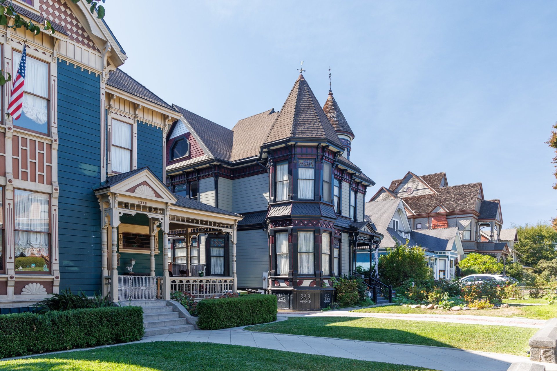 Row of historic Victorian houses along sunny residential street